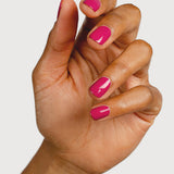 A medium-brown hand with fingers loosely curled to display glossy raspberry-pink nails painted in Sienna Byron Bay Goddess.