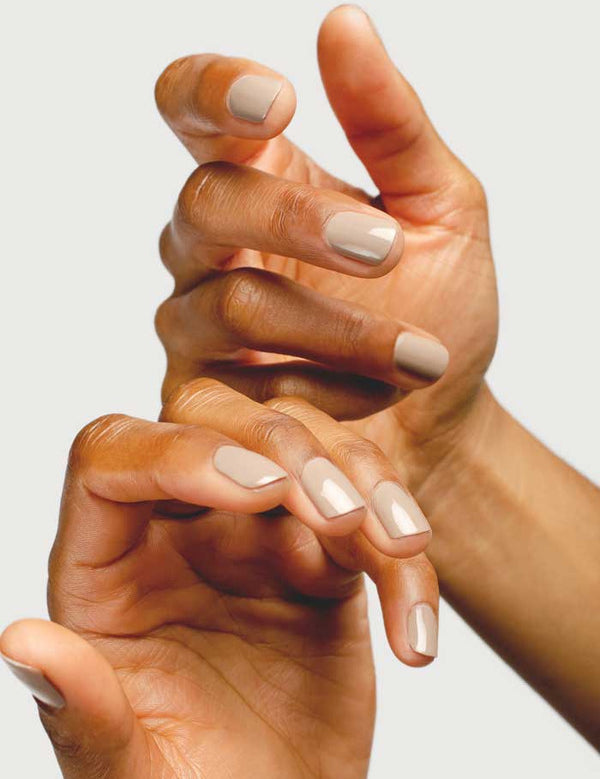 Close-up of hands wearing Sienna Byron Bay Calm nail polish in a soft creamy neutral shade.