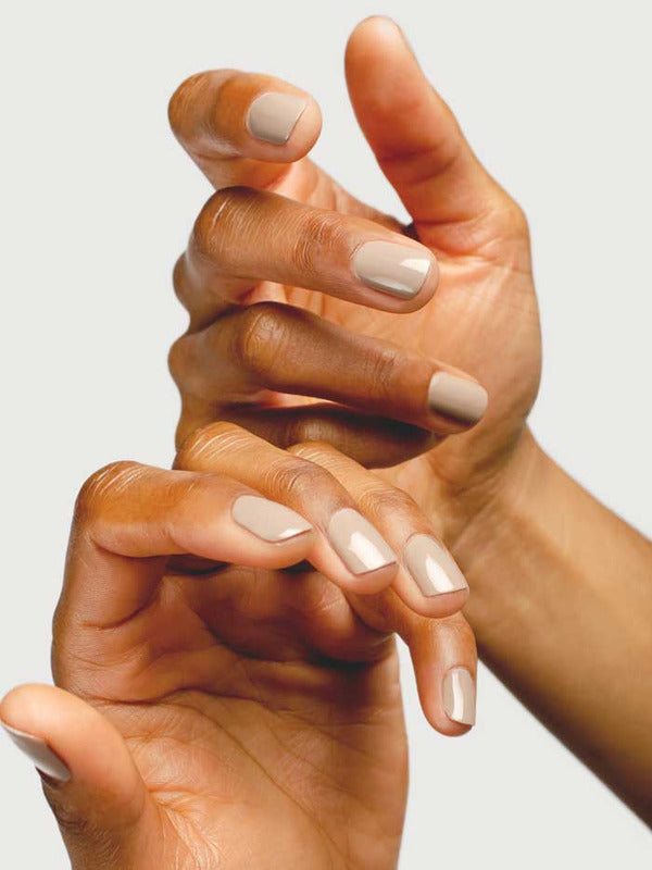 Close-up of hands wearing Sienna Byron Bay Calm nail polish in a soft creamy neutral shade.