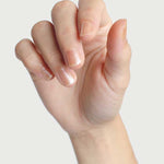 Close-up of a hand wearing Sienna Byron Bay Embrace nail polish in a sheer blush shade.