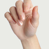 Close-up of a hand wearing Sienna Byron Bay Embrace nail polish in a sheer blush shade.