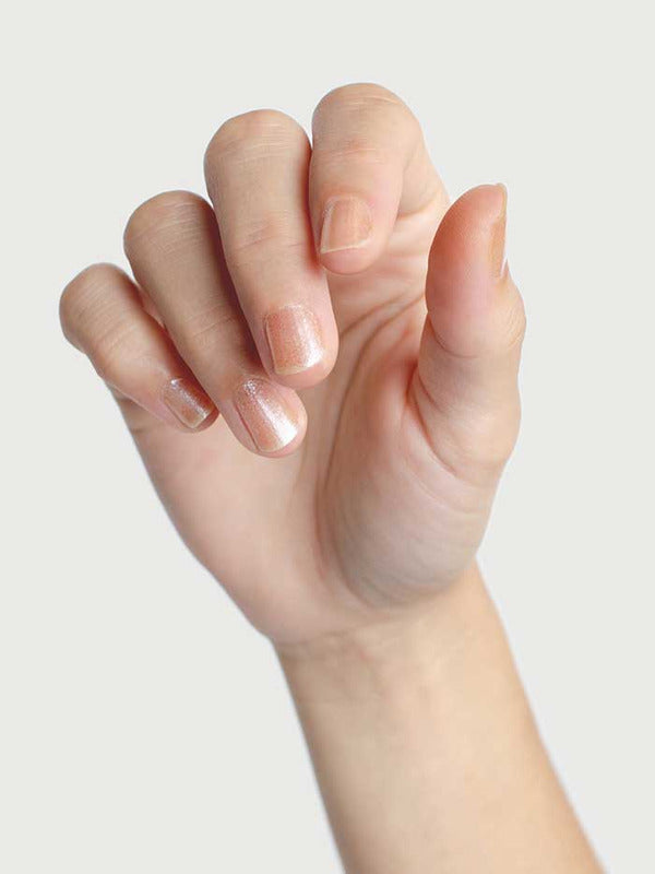 Close-up of a hand wearing Sienna Byron Bay Embrace nail polish in a sheer blush shade.