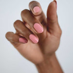 Close-up of a hand wearing Sienna Byron Bay Glowing nail polish, showing the soft pink manicure shade on natural nails.