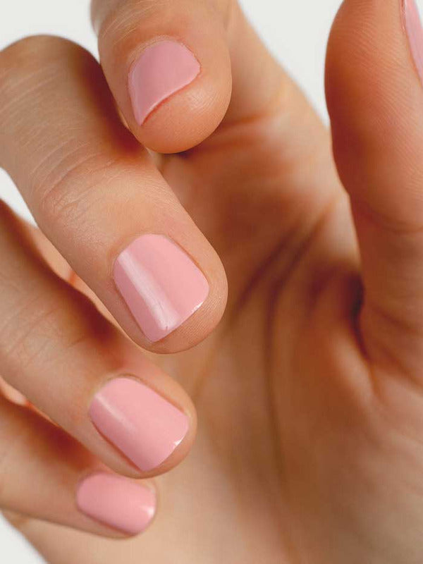 Close-up of natural nails wearing Sienna Byron Bay Peony nail polish in a soft pink shade.