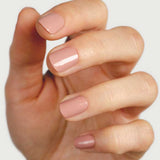 Close-up of a hand wearing Sienna Byron Bay Rosie nail polish in a soft rosy neutral shade.