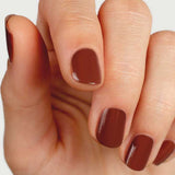 Close-up of natural nails wearing Sienna Byron Bay Sienna nail polish in a warm earthy brown shade.