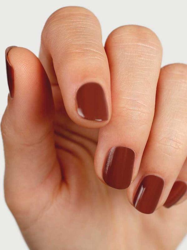 Close-up of natural nails wearing Sienna Byron Bay Sienna nail polish in a warm earthy brown shade.