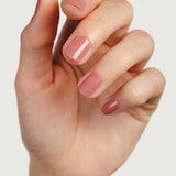 Close-up of a hand wearing Sienna Byron Bay Stone nail polish, showing the soft neutral manicure shade on natural nails.