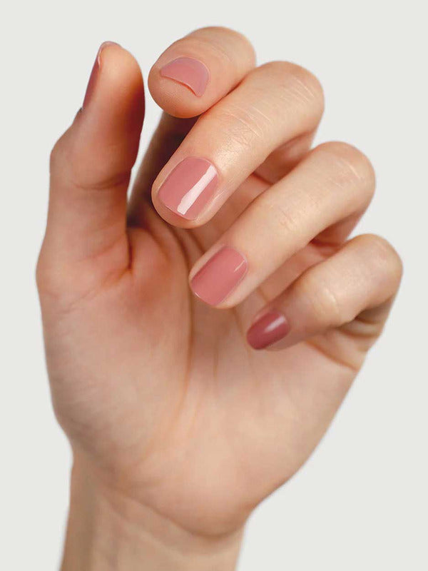 Close-up of a hand wearing Sienna Byron Bay Stone nail polish, showing the soft neutral manicure shade on natural nails.