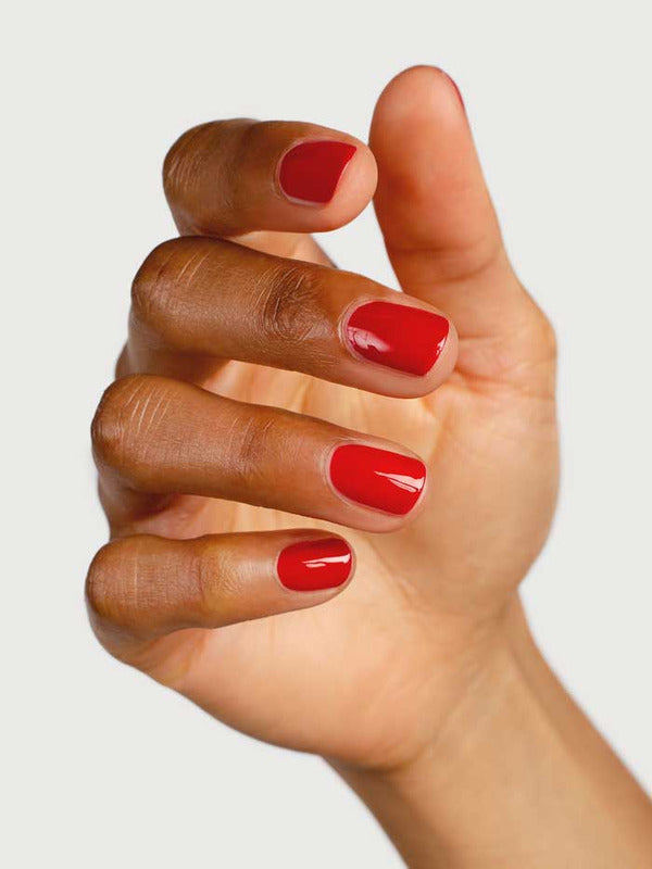 Close-up of a hand wearing Sienna Byron Bay Tempest nail polish, showing the glossy red manicure shade.