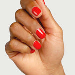Hand modelling Sienna Byron Bay Passion nail polish, a vivid warm red shade with a high-gloss finish.