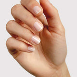 Hand modelling Sienna Byron Bay Peace nail polish, a soft sheer nude-pink shade with a glossy finish.