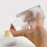 Sienna Byron Bay Strengthening Nail Polish Remover bottle held over a reusable cotton pad.