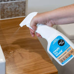 Hand spraying Simply Clean Simply NO Mould in a bathroom