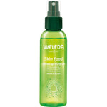 A green 100ml spray bottle of Weleda Skin Food Ultra Light Dry Oil, a fast-absorbing natural moisturising spray for nourishing normal to dry skin, is shown against a white background.