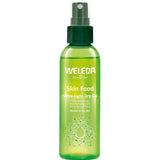 A green 100ml spray bottle of Weleda Skin Food Ultra Light Dry Oil, a fast-absorbing natural moisturising spray for nourishing normal to dry skin, is shown against a white background.