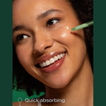 Applying Weleda Skin Food Super Serum to the cheek