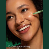 Applying Weleda Skin Food Super Serum to the cheek