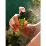Weleda Skin Food Ultra-Light Dry Oil being sprayed onto skin