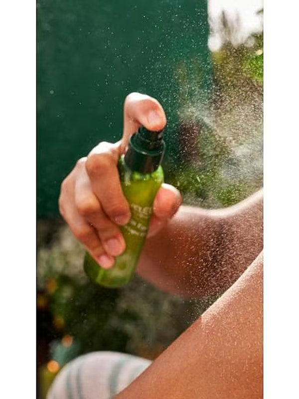 Weleda Skin Food Ultra-Light Dry Oil being sprayed onto skin