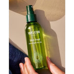 Weleda Skin Food Ultra-Light Dry Oil held in warm sunlight
