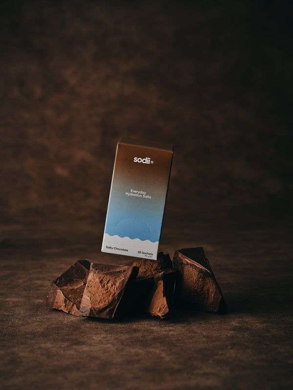 Sodii Everyday Hydration Salts Salty Chocolate product styled on dark rocks