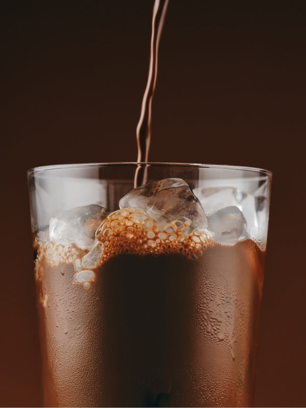 Sodii Everyday Hydration Salts Salty Chocolate being poured into an iced glass