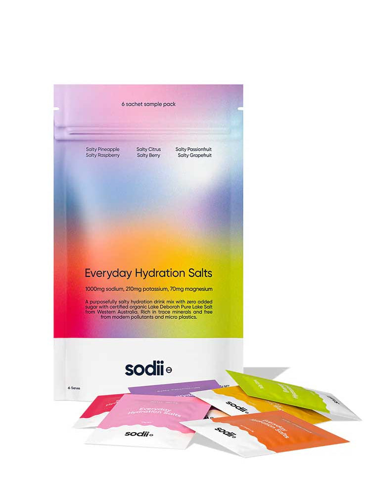 A vibrant pouch of Sodii Everyday Hydration Salts Mixed Flavour 6pk stands upright, displaying six assorted electrolyte powder sachets in front—an ideal hydration sample pack.