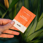Sodii Everyday Hydration Salts Salty Grapefruit held against tropical greenery