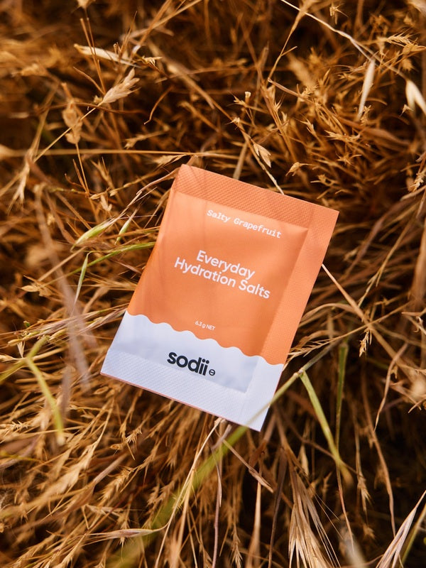 Sodii Everyday Hydration Salts Salty Grapefruit styled on natural straw