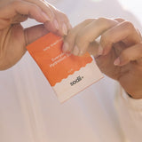 Sodii Everyday Hydration Salts Salty Grapefruit sachet being opened in bright sunlight