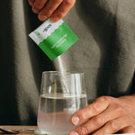 Sodii Everyday Hydration Salts Salty Kiwi being poured into a drinking glass