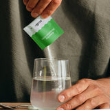 Sodii Everyday Hydration Salts Salty Kiwi being poured into a drinking glass