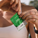 Sodii Everyday Hydration Salts Salty Kiwi sachet being opened outdoors