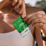 Sodii Everyday Hydration Salts Salty Kiwi sachet being opened outdoors