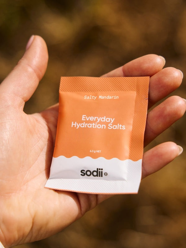 Sodii Everyday Hydration Salts Salty Mandarin single serve held outdoors