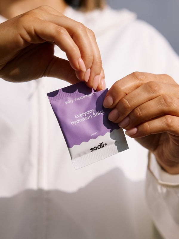 Sodii Everyday Hydration Salts Salty Passionfruit sachet being opened