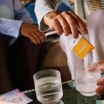 Sodii Everyday Hydration Salts Salty Pineapple being mixed into a glass at home