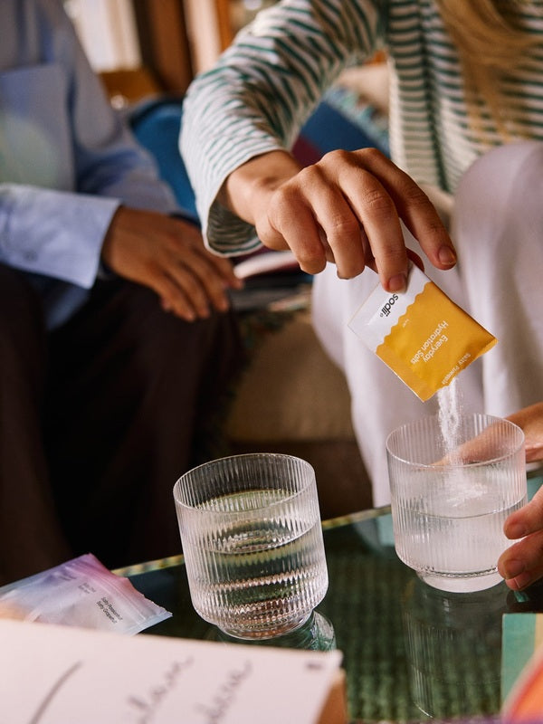 Sodii Everyday Hydration Salts Salty Pineapple being mixed into a glass at home