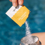 Sodii Everyday Hydration Salts Salty Pineapple being poured into a sports bottle