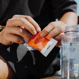 Sodii Everyday Hydration Salts Salty Raspberry being mixed into a water bottle