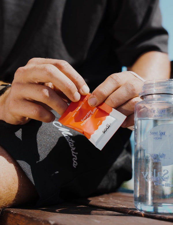 Sodii Everyday Hydration Salts Salty Raspberry being mixed into a water bottle