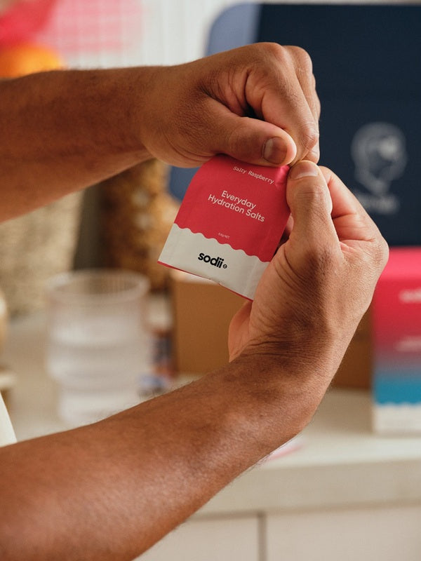 Sodii Everyday Hydration Salts Salty Raspberry sachet being opened at home