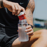 Sodii Everyday Hydration Salts Salty Raspberry being mixed into a sports bottle