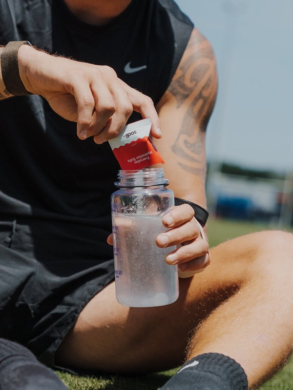 Sodii Everyday Hydration Salts Salty Raspberry being mixed into a sports bottle