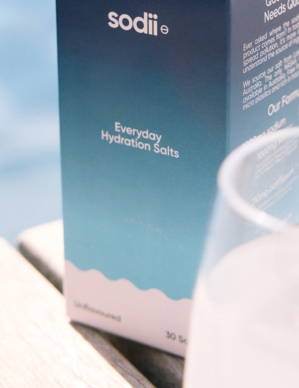 Sodii Everyday Hydration Salts Unflavoured styled beside a drinking glass