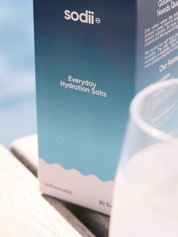 Sodii Everyday Hydration Salts Unflavoured styled beside a drinking glass