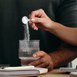 Sodii Everyday Hydration Salts Unflavoured being measured into a drinking glass