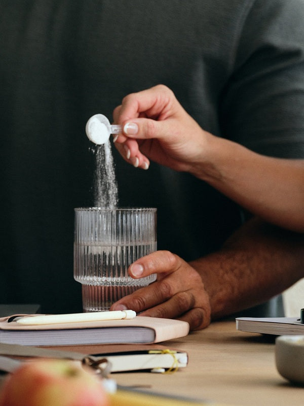 Sodii Everyday Hydration Salts Unflavoured being measured into a drinking glass