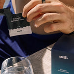 Sodii Everyday Hydration Salts Unflavoured being opened at a cafe table